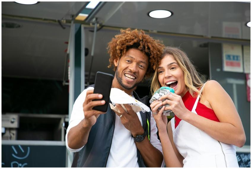 Cheerful friends taking a selfie while enjoying de