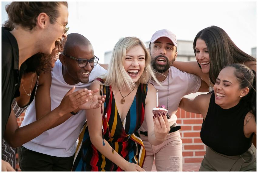Joyful friends celebrating a birthday on a rooftop