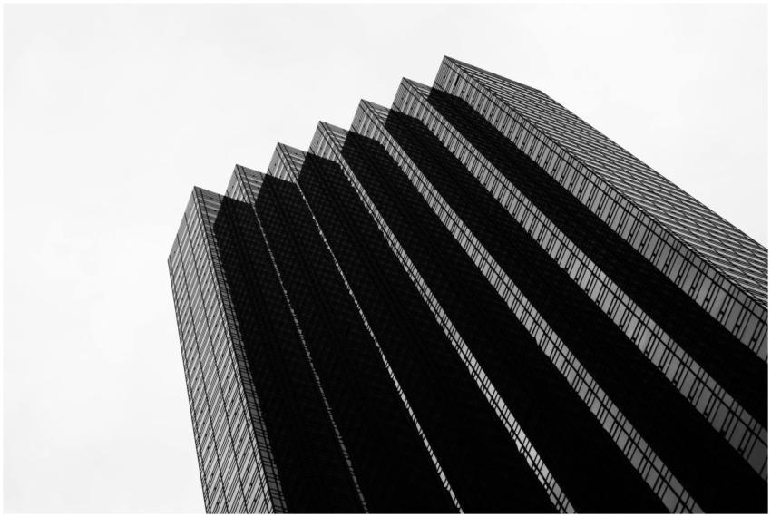 Low-angle view of a modern glass skyscraper with a