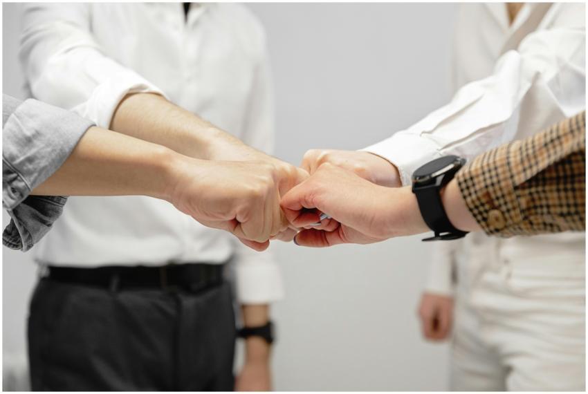 Close-up of diverse team members doing a fist bump