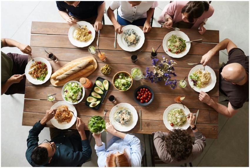 A diverse group of adults enjoying a shared meal i