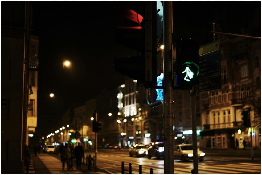 City street in Poznań at night with traffic lights