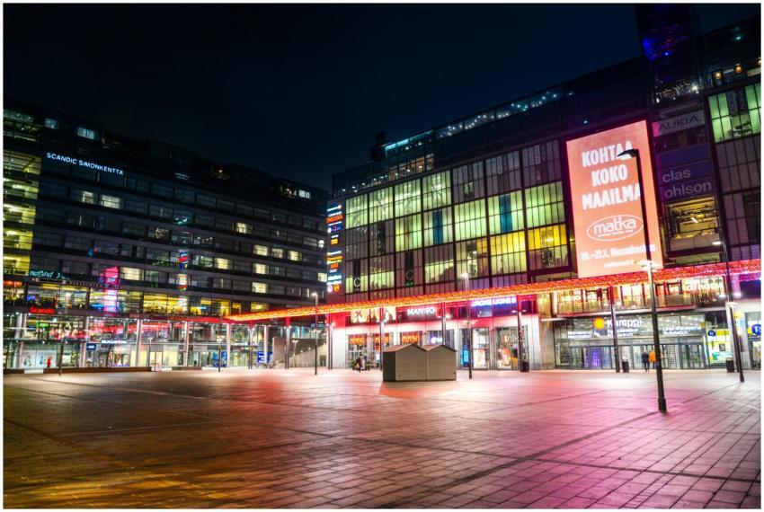 Illuminated city square at night showcasing modern