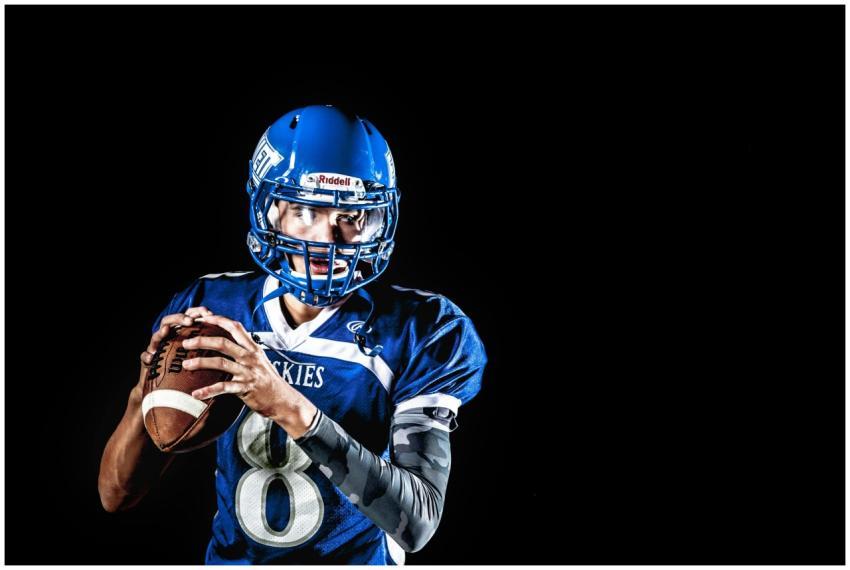 A focused American football quarterback poised to