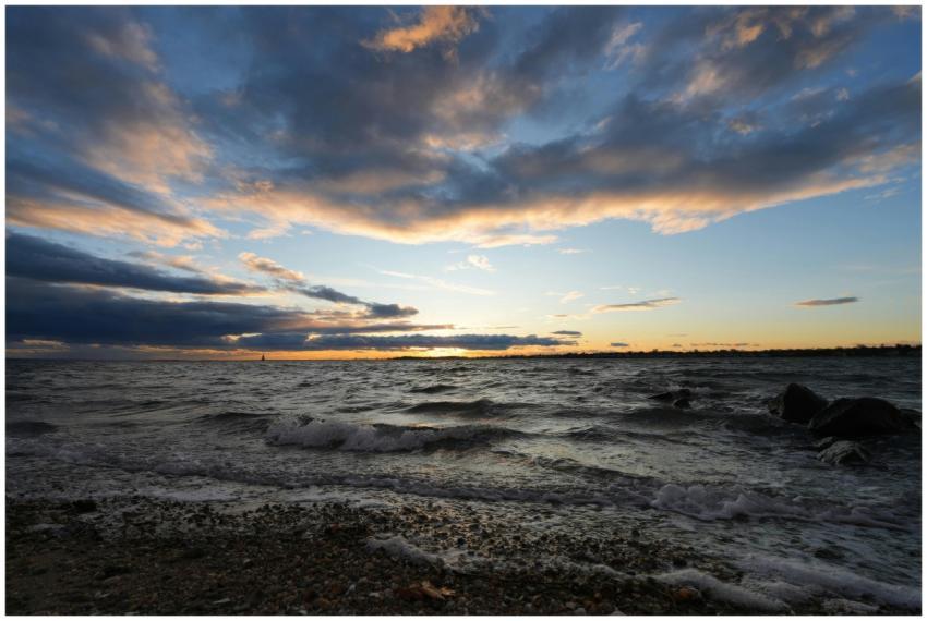 Stunning scenic sunset over ocean waves with drama