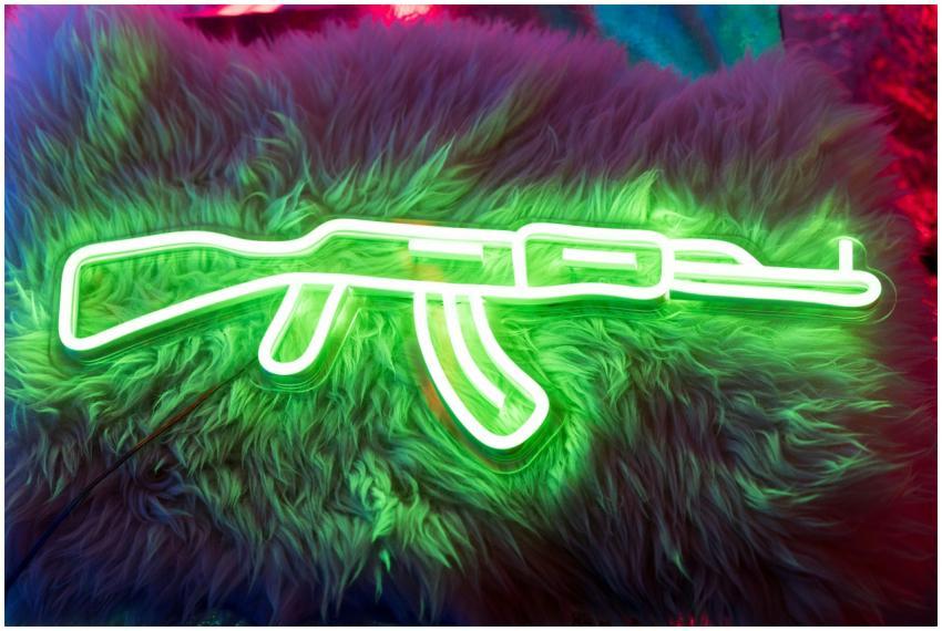 Bright neon gun artwork on fur texture, illuminati