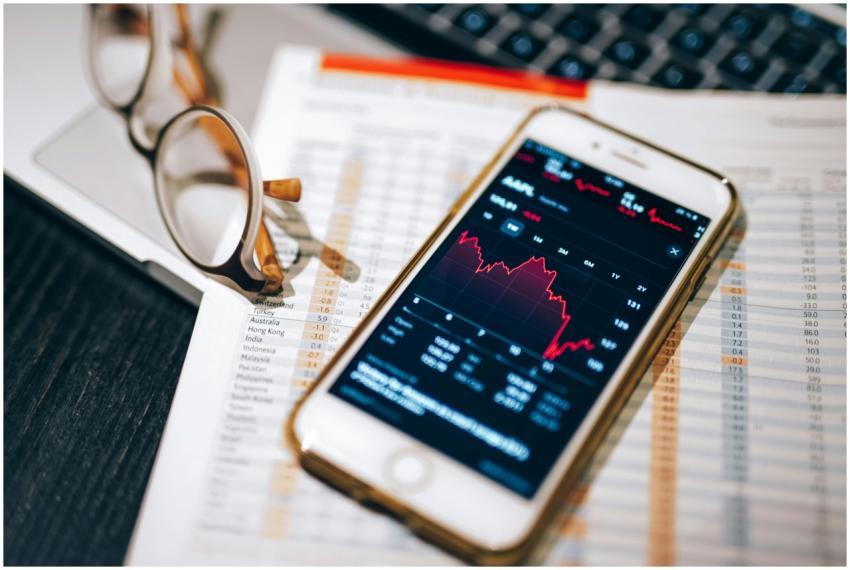 Smartphone displaying stock market chart on a fina