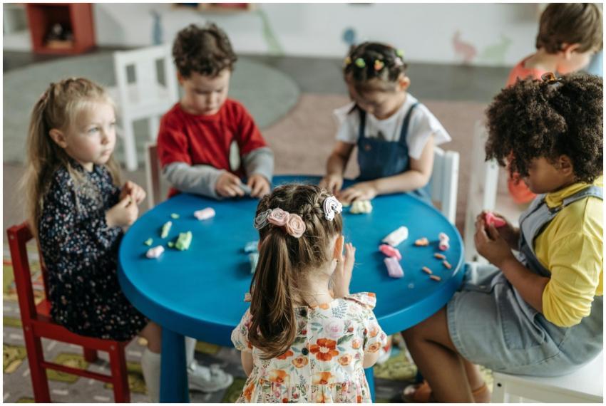Group of preschool children playing with clay at a