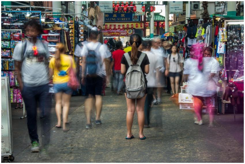 Busy street market in Kuala Lumpur with blurred mo