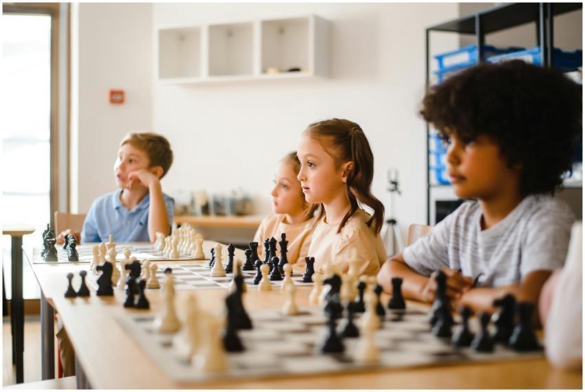 Kids focused on an intense chess game in a classro