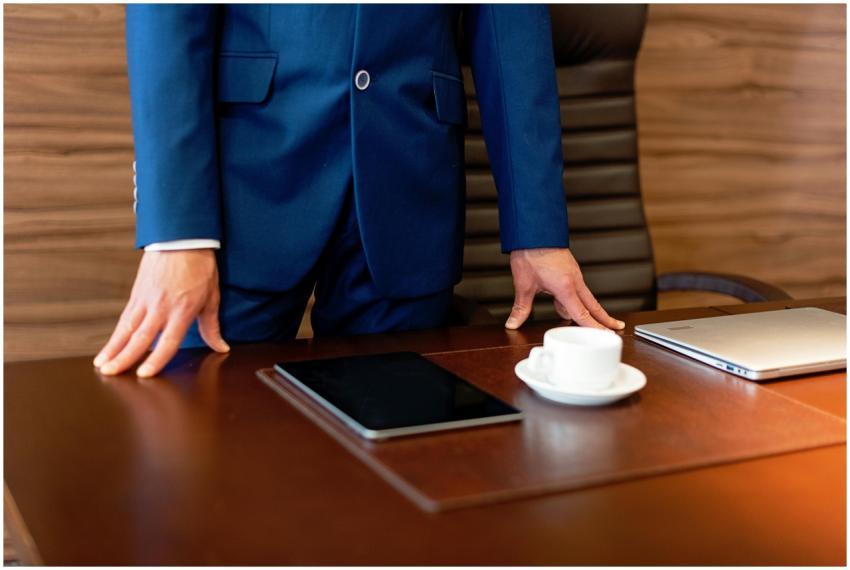 Professional businessman in blue suit standing by
