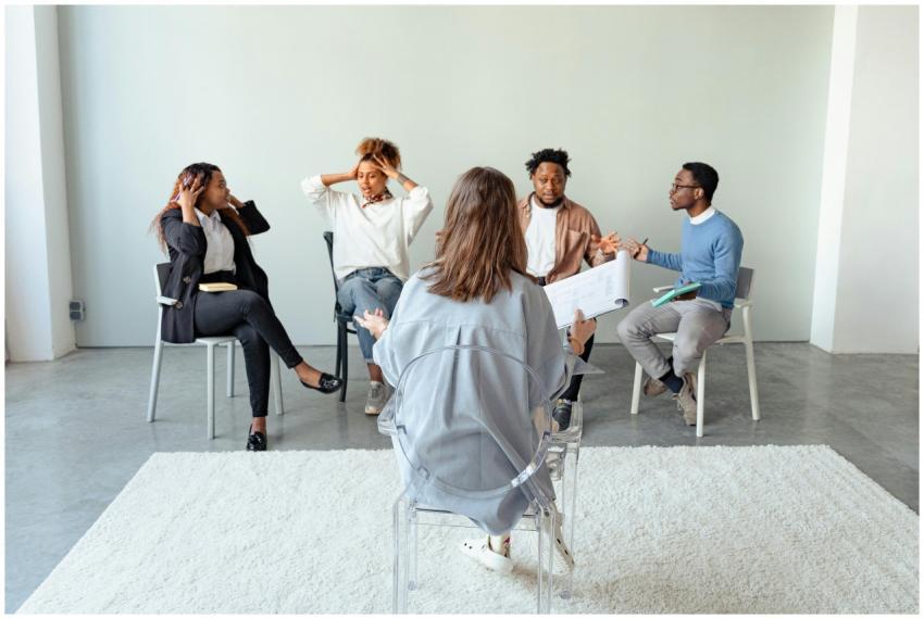 People engaging in a group therapy session indoors