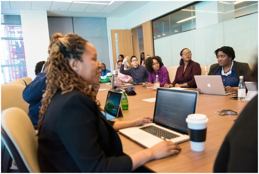 A diverse group of professionals engaging in a tea
