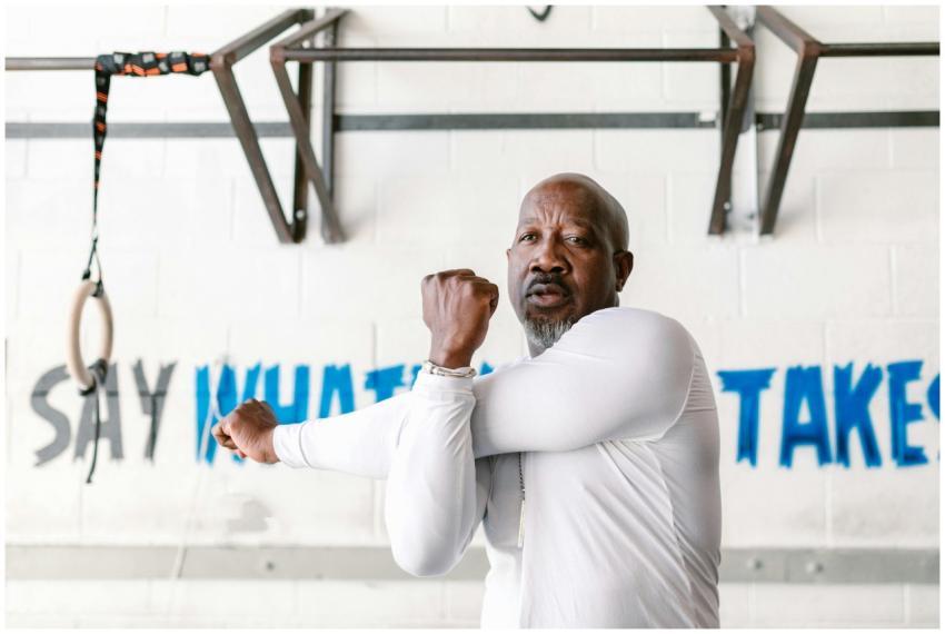 A middle-aged African American man stretching in a