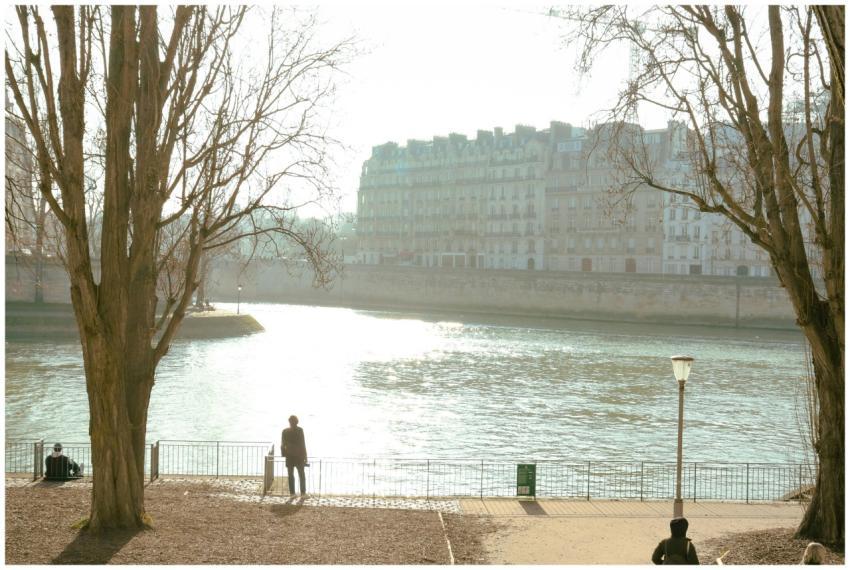 A serene morning walk by the Seine River in Paris,