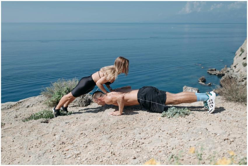 A man and woman perform outdoor fitness exercises