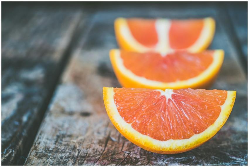 Vibrant orange slices arranged on a rustic wooden