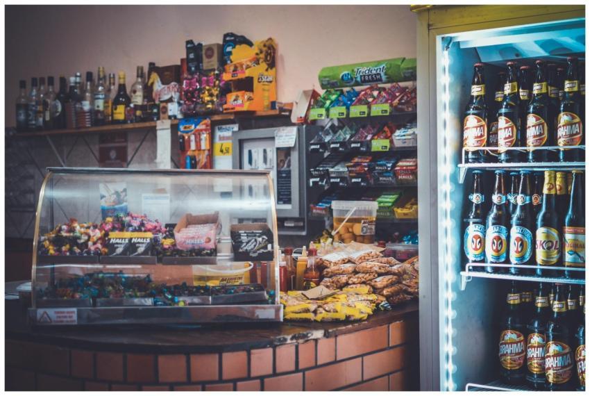A well-stocked convenience store counter with snac