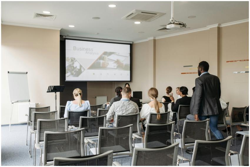 Business conference attendees listening to a prese