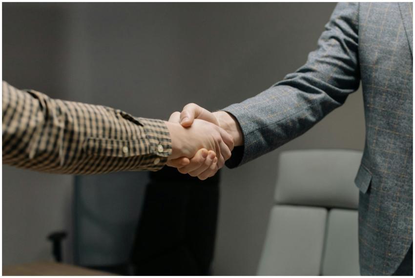 Close-up of two professionals shaking hands in an