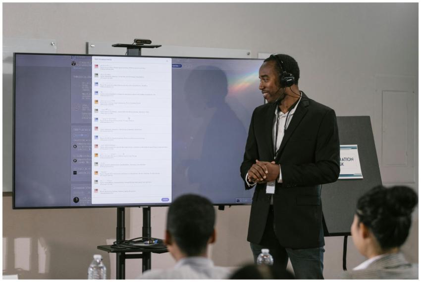 An adult man presents at a technology seminar usin