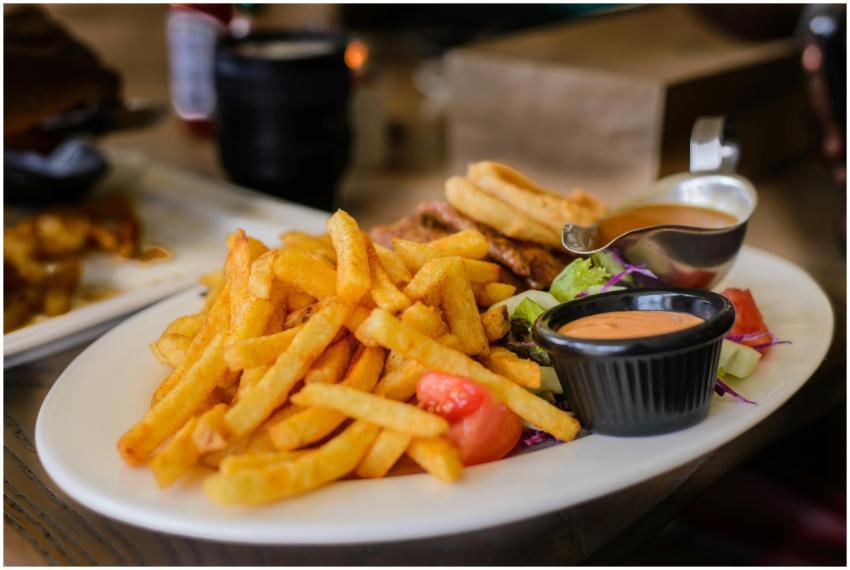 Delicious plate of golden french fries with dippin