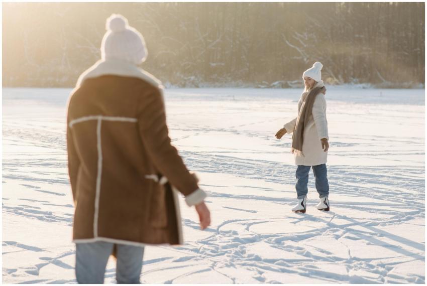 A couple enjoys ice skating on a snowy outdoor rin