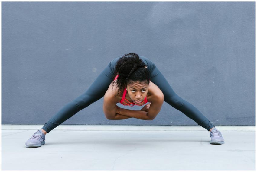 African American woman in activewear performing a