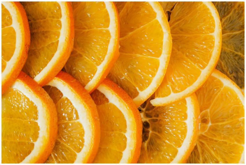 Top view of delicious sliced oranges arranged near