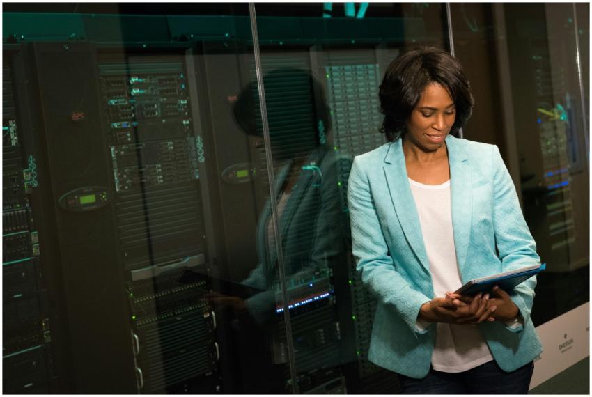 Female IT professional examining data servers in a