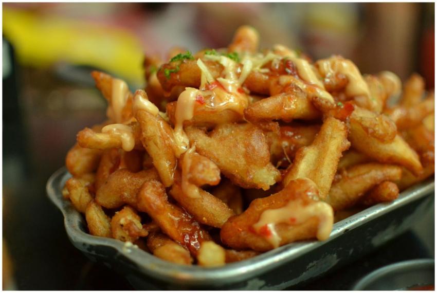 Delicious close-up of crispy french fries topped w