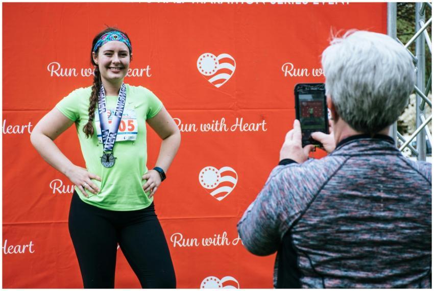 Woman posing with her medal after completing a 'Ru