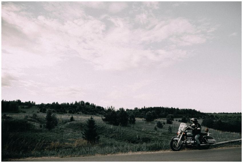 A motorcyclist rides through the picturesque hills