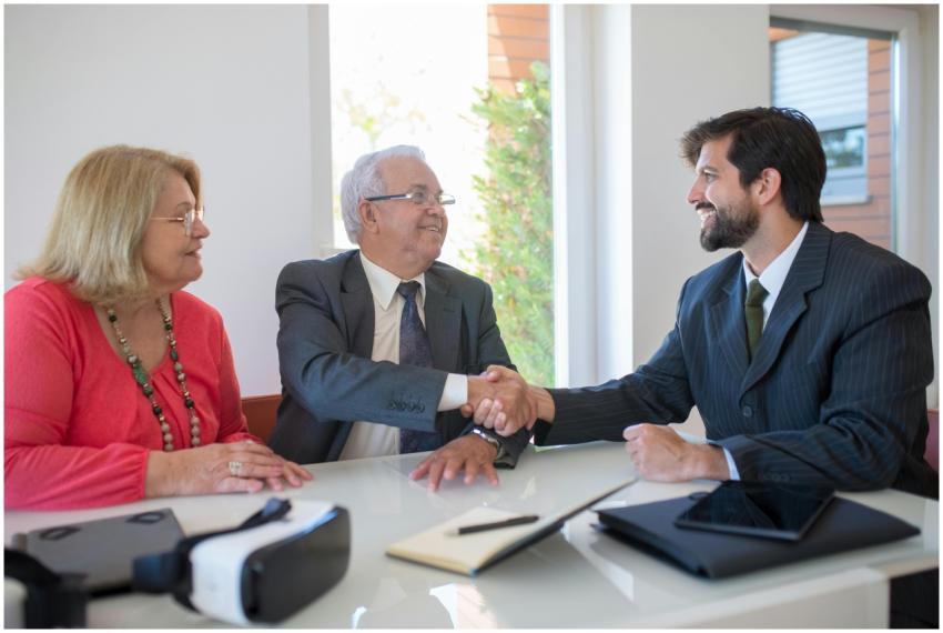 Three business professionals shaking hands during