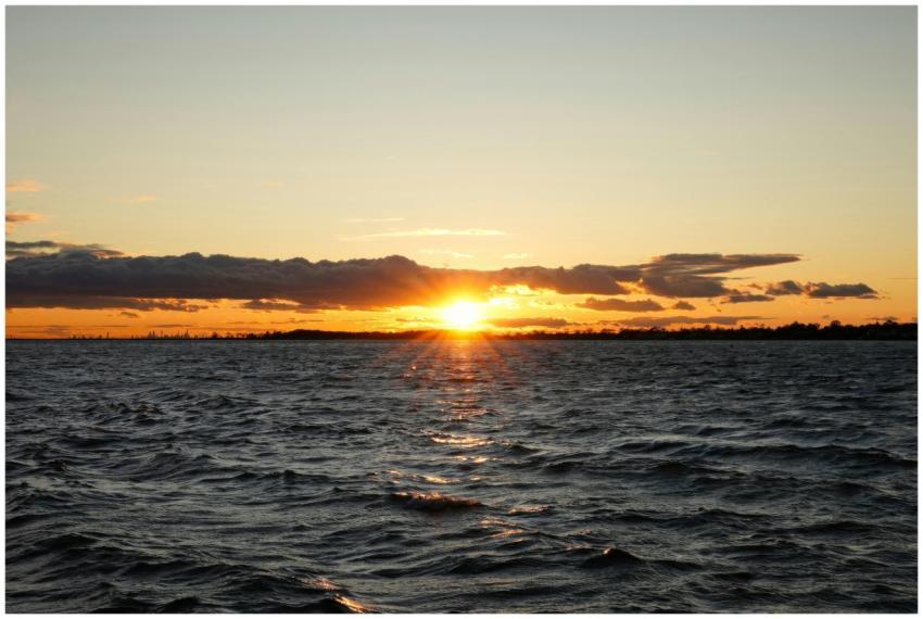 Beautiful sunset over ocean with dramatic clouds a