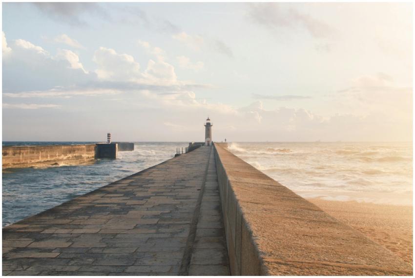 Tranquil view of a lighthouse on a pier by the oce