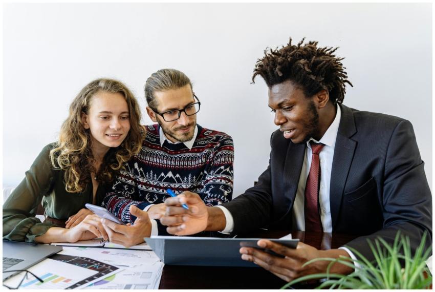 Three professionals engaging in a collaborative bu