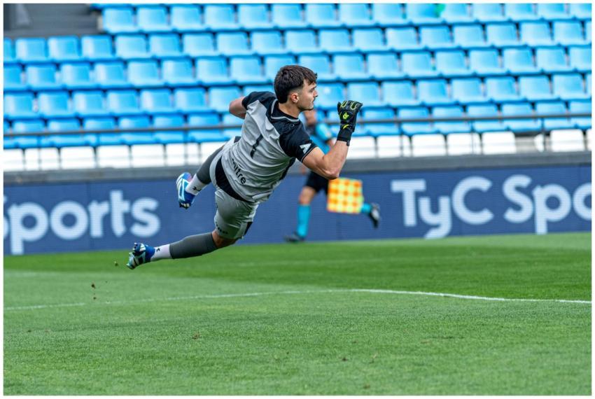 A soccer goalkeeper making a leaping save during a