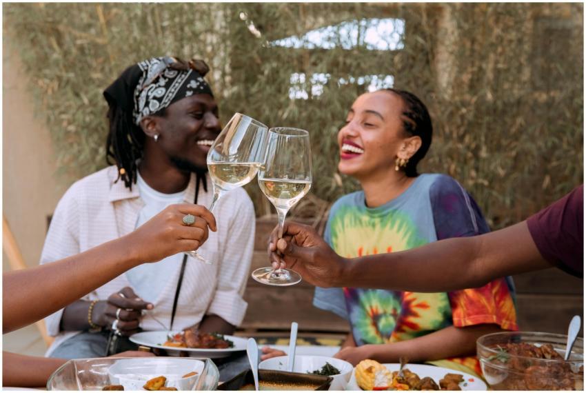 Friends clinking wine glasses in a lively outdoor