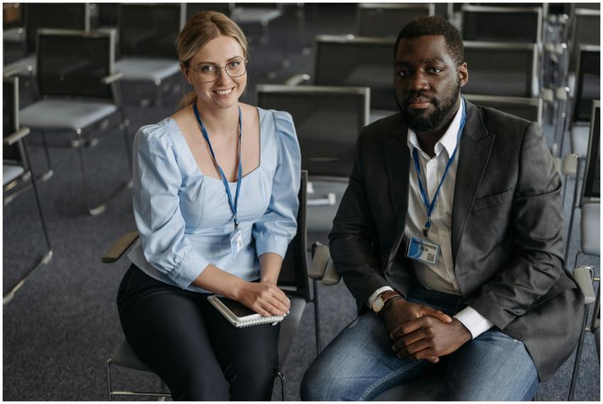 A man and woman smiling in a conference room. Idea
