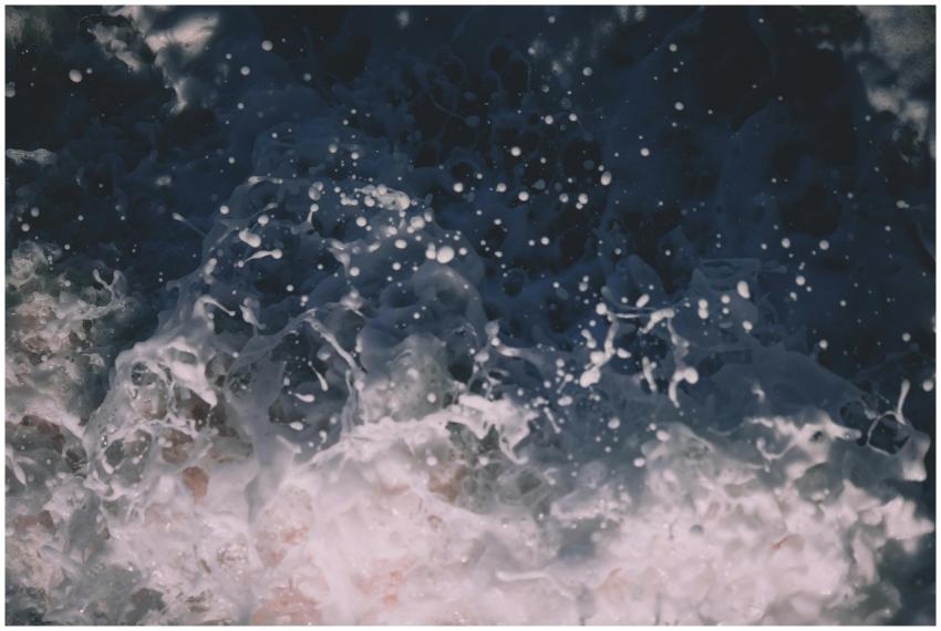 Close-up view of a powerful ocean wave crashing wi