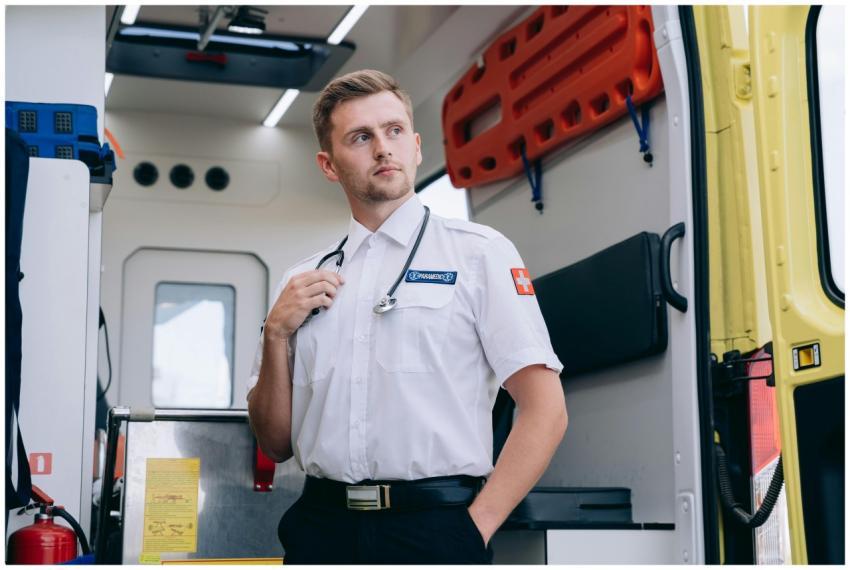 Male paramedic in uniform standing inside an ambul