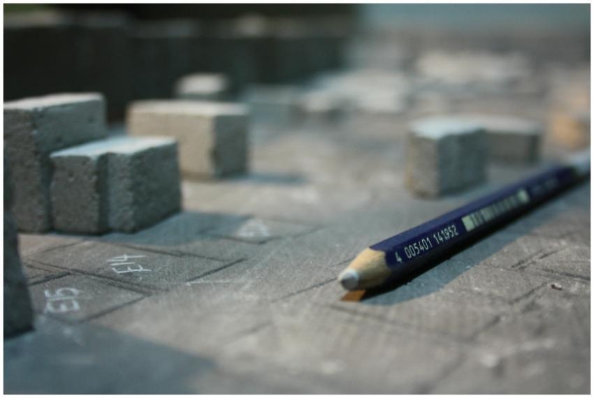 A detailed close-up of a pencil alongside architec