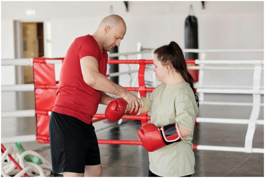 A trainer assists a woman with Down syndrome in a