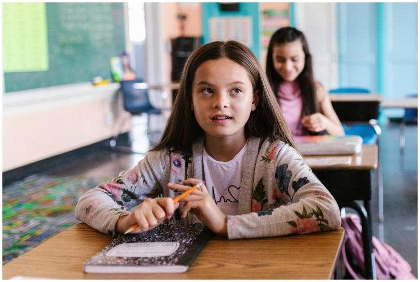 Two students attentively participate in a classroo