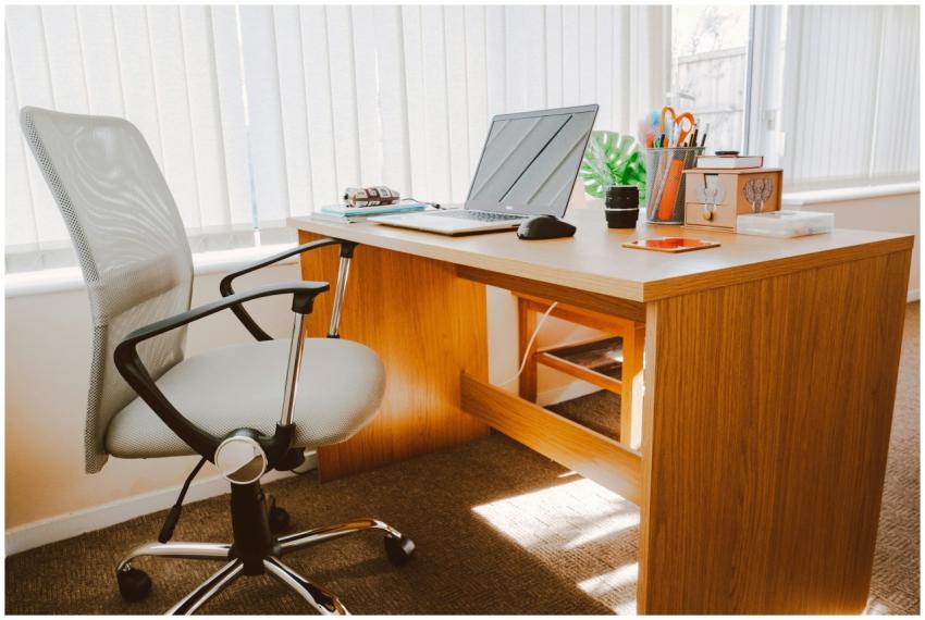 A modern office workspace featuring a wooden desk,