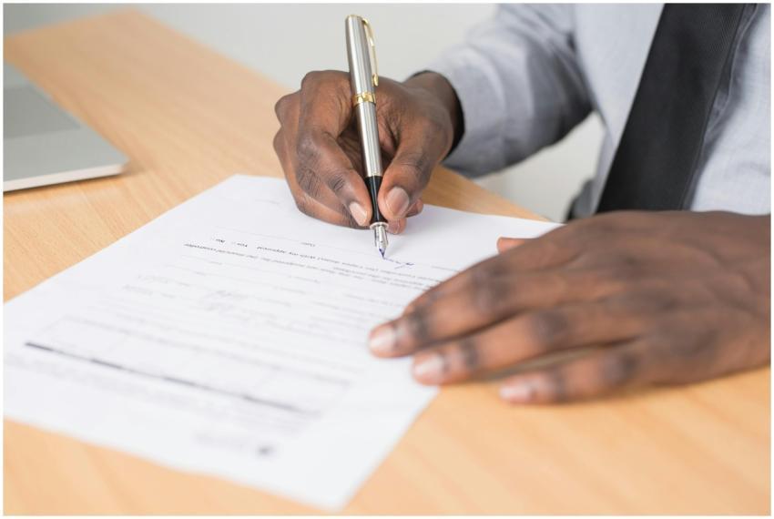Close-up of a businessman signing a contract at an