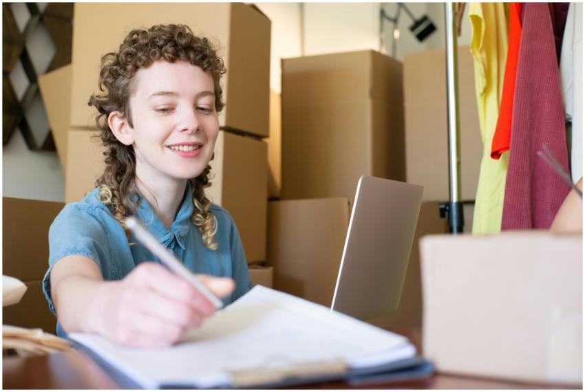 Smiling young woman managing a small business with