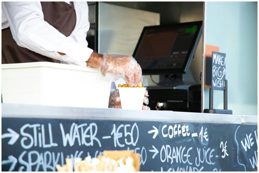 Low angle of crop anonymous male seller with cup o