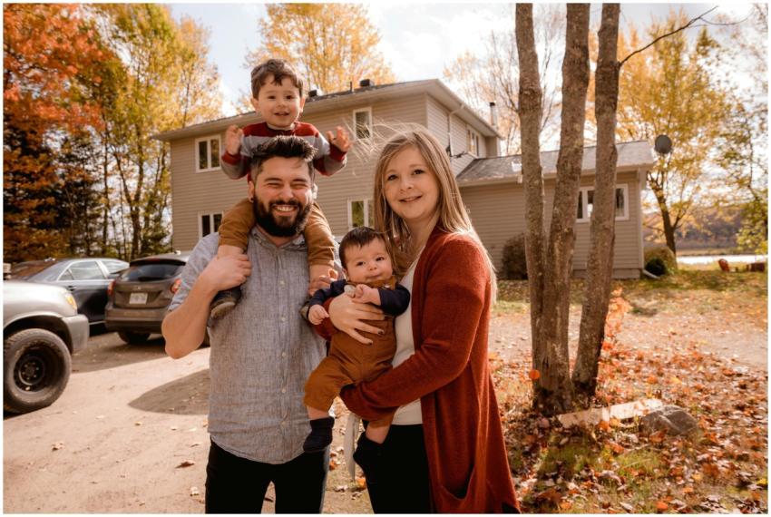 Smiling family of four enjoying a sunny autumn day